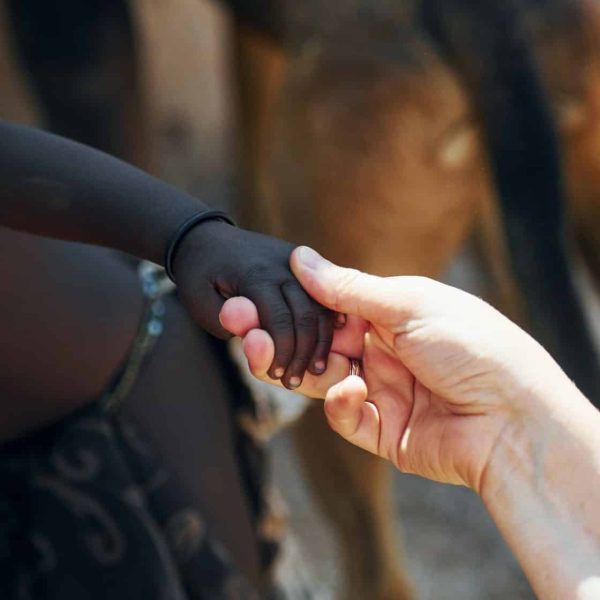 touching-hands-greetings-gesture-tourists-is-in-namibia-with-african-kids-e1659823626163.jpg